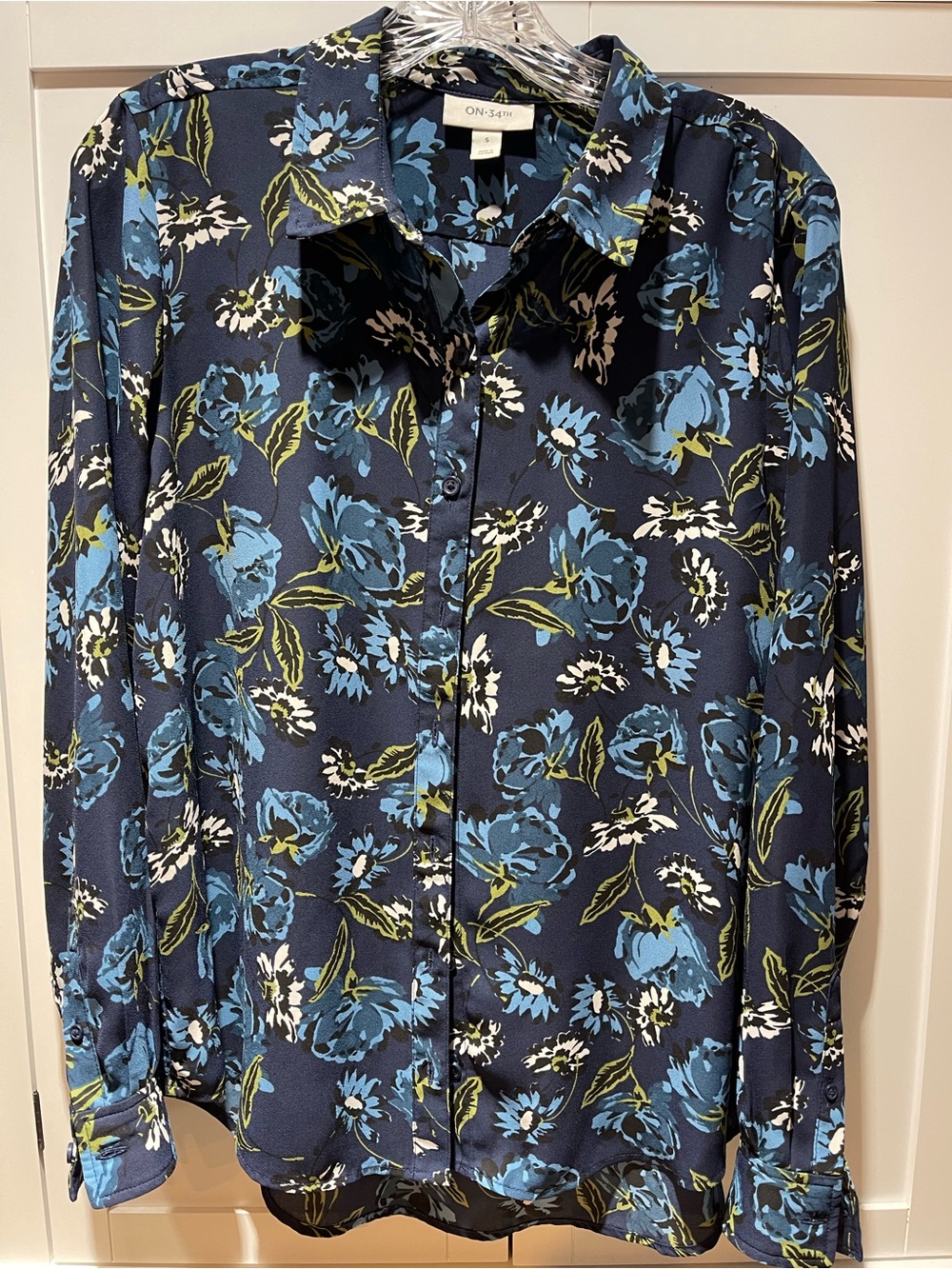 Women’s Navy Blue Floral Button-Up blouse.